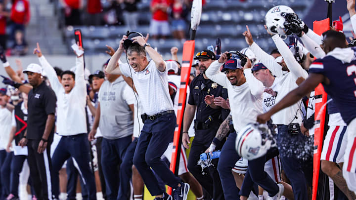 Nov 8, 2025; Tucson, Arizona, USA; Arizona Wildcats head coach Brent Brennan takes off his headset as they secure the win against the Kansas Jayhawks at the end of the fourth quarter of the game at Arizona Stadium. Mandatory Credit: Aryanna Frank-Imagn Images