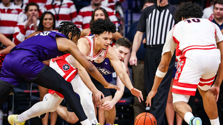 Dec 16, 2025; Tucson, Arizona, USA; Arizona Wildcats guard Brayden Burries (5) and the Abilene Christian Wildcats reach to grab possession over the ball during the second half of the game at McKale Memorial Center. Mandatory Credit: Aryanna Frank-Imagn Images