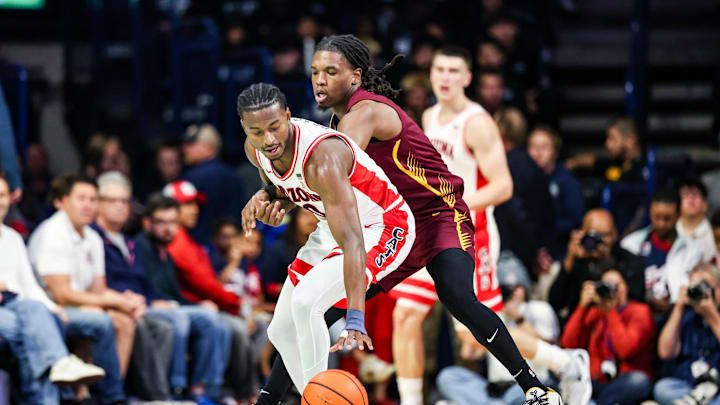 Dec 22, 2025; Tucson, Arizona, USA; Bethune-Cookman Wildcats guard Jordan Johnson (11) fouls Arizona Wildcats guard Jaden Bradley (0) during the first half of the game at McKale Memorial Center. Mandatory Credit: Aryanna Frank-Imagn Images