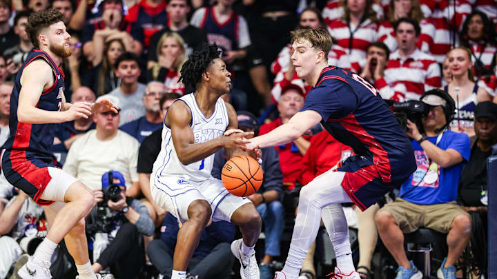 Feb 18, 2026; Tucson, Arizona, USA; Arizona Wildcats center Motiejus Krivas (13) hits the ball out of the hands of Brigham Young Cougars guard Robert Wright III (1) during the second half of the game at McKale Memorial Center. Mandatory Credit: Aryanna Frank-Imagn Images