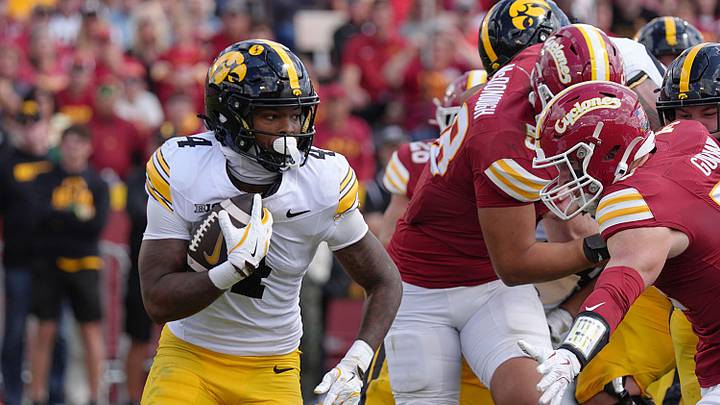 Iowa Hawkeyes running back Jaziun Patterson (4) runs with the ball asIowa State Cyclones' linebacker Beau Goodwin (34) goes for a tackle during the fourth quarter in the Cy-Hawk football at Jack Trice Stadium on Sept. 6, 2025, in Ames, Iowa