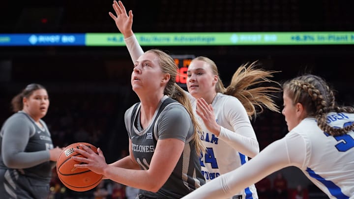 Iowa State Cyclones' guard Emily Ryan (11) drives to the basket around BYU Cougars forward/guard Brinley Cannon (24) and forward Hattie Ogden (33) during the fourth quarter in the Big-12 women’s basketball at Hilton Coliseum on Wednesday, Jan. 22, 2025, in Ames, Iowa.