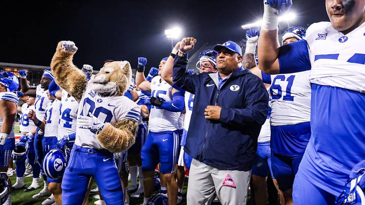 Oct 11, 2025; Tucson, Arizona, USA; Brigham Young Cougars head coach Kalani Sitake celebrates a win against the Arizona Wildcats after overtime with his team and the crowd at Arizona Stadium. Mandatory Credit: Aryanna Frank-Imagn Images