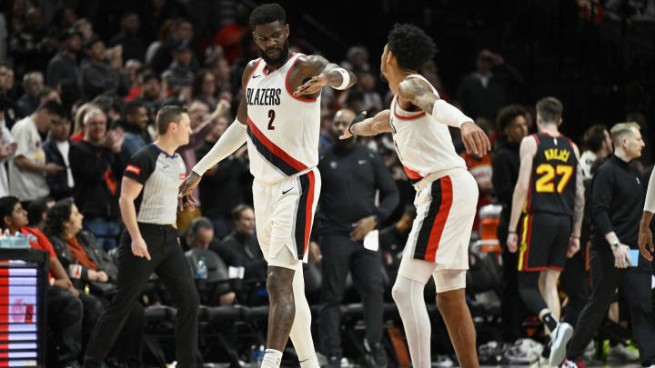 Mar 13, 2024; Portland, Oregon, USA; Portland Trail Blazers center Deandre Ayton (2) gives Portland Trail Blazers guard Anfernee Simons (1) a high-five during the second half against the Atlanta Hawks at Moda Center. Mandatory Credit: Troy Wayrynen-USA TODAY Sports