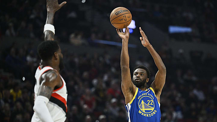 Apr 11, 2024; Portland, Oregon, USA; Golden State Warriors forward Andrew Wiggins (22) shoots a jump shot during the firs half against Portland Trail Blazers center Deandre Ayton (2) at Moda Center. Mandatory Credit: Troy Wayrynen-Imagn Images