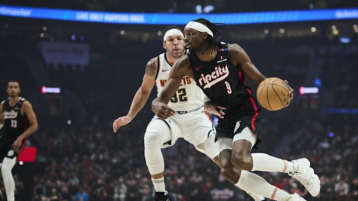Dec 19, 2024; Portland, Oregon, USA; Portland Trail Blazers forward Jerami Grant (9) drives to the basket during the first half against Denver Nuggets forward Aaron Gordon (32) at Moda Center. Mandatory Credit: Troy Wayrynen-Imagn Images