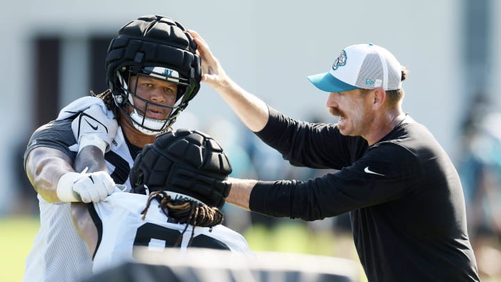 Jaguars defensive coordinator Ryan Nielsen gives instructions to Jacksonville Jaguars defensive end Roy Robertson-Harris (95) and defensive end Tyler Lacy (93) during the fourth day of the NFL football training camp practice session Saturday, July 27, 2024 at EverBank Stadium's Miller Electric Center in Jacksonville, Fla.