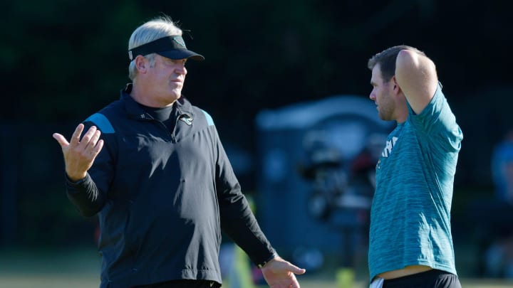 Jacksonville Jaguars head coach Doug Pederson talks with offensive coordinator Press Taylor on the field ahead of the start of Wednesday morning's training camp session. 