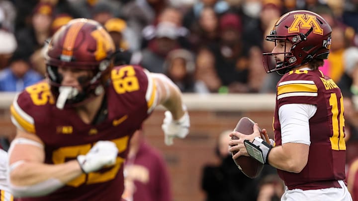 Nov 23, 2024; Minneapolis, Minnesota, USA; Minnesota Golden Gophers quarterback Max Brosmer (16) takes a snap against the Penn State Nittany Lions during the first quarter at Huntington Bank Stadium. Mandatory Credit: Matt Krohn-Imagn Images
