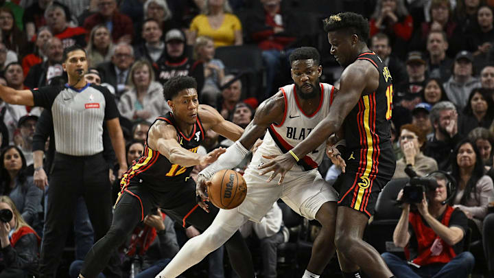 Mar 13, 2024; Portland, Oregon, USA; Portland Trail Blazers center Deandre Ayton (2) drives to the basket during the second half as he is double teamed by Atlanta Hawks center Clint Capela (15) and forward De'Andre Hunter (12) at Moda Center. Mandatory Credit: Troy Wayrynen-Imagn Images