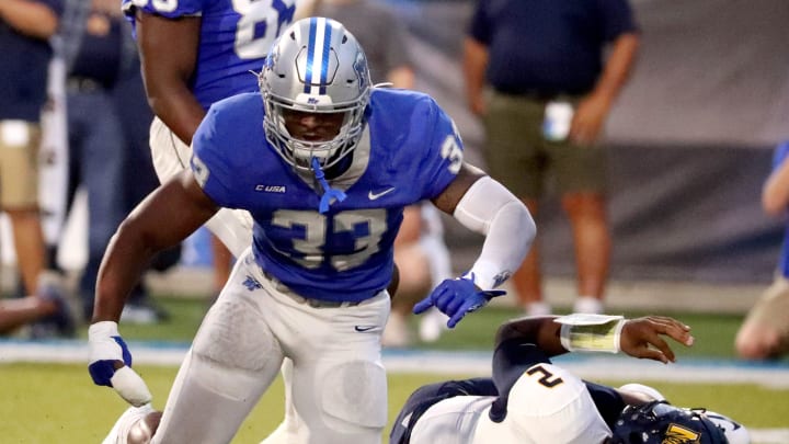 MTSU linebacker Sam Brumfield (33) celebrates sacking Murray State quarterback DJ Williams (2) during a football game at MTSU's Floyd Stadium on Saturday, Sept. 16, 2023.