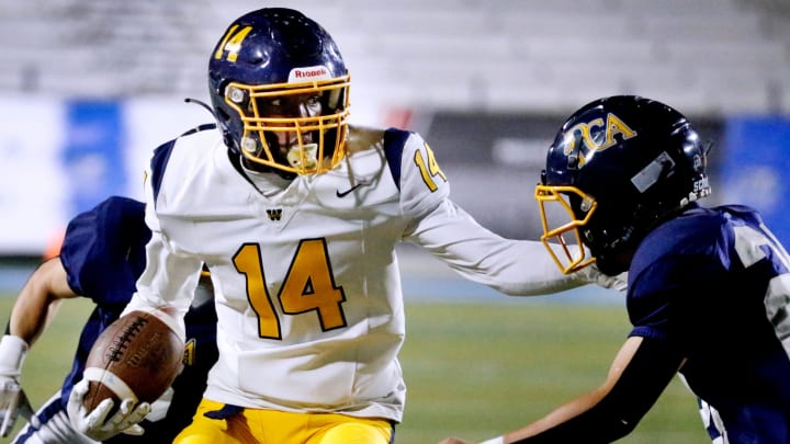 The Webb School's Joel Wyatt (14) runs the ball as PCA   s Joshua Meier (24) moves in for a tackle during the football game at MTSU on Thursday, Oct. 26, 2023.