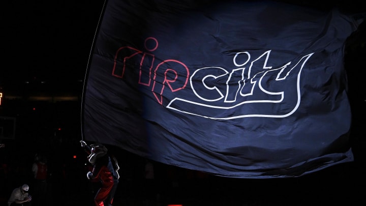 Apr 12, 2024; Portland, Oregon, USA; Portland Trail Blazers mascot Blaze waves a flag before a game against the Houston Rockets at Moda Center. Mandatory Credit: Troy Wayrynen-USA TODAY Sports