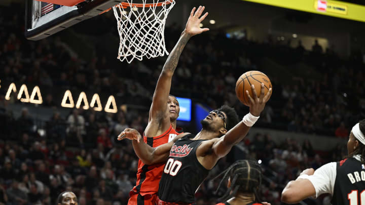 Apr 12, 2024; Portland, Oregon, USA; Portland Trail Blazers guard Scoot Henderson (00) drives to the basket during the second half against Houston Rockets forward Jabari Smith Jr. (10) at Moda Center. Mandatory Credit: Troy Wayrynen-USA TODAY Sports