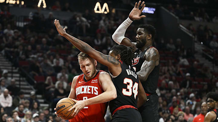 Apr 12, 2024; Portland, Oregon, USA; Houston Rockets center Jock Landale (2) drives to the basket during the first half against Portland Trail Blazers forward Jabari Walker (34) and center Deandre Ayton (2) at Moda Center. Mandatory Credit: Troy Wayrynen-Imagn Images