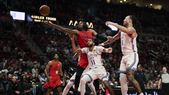 Jan 26, 2025; Portland, Oregon, USA; Portland Trail Blazers center Robert Williams III (35) reaches for a rebound during the first half against Oklahoma City Thunder guard Isaiah Joe (11) at Moda Center. Mandatory Credit: Troy Wayrynen-Imagn Images Jan 26, 2025; Portland, Oregon, USA; Portland Trail Blazers center Robert Williams III (35) reaches for a rebound during the first half against Oklahoma City Thunder guard Isaiah Joe (11) at Moda Center. Mandatory Credit: Troy Wayrynen-Imagn Images