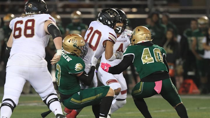 Oaks Christian's Deshonne Redeaux runs the ball against  St. Bonaventure during the first quarter of their Marmonte League game at Ventura College