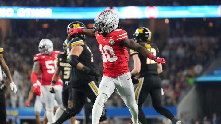 Dec 29, 2023; Arlington, Texas, USA; Ohio State Buckeyes cornerback Denzel Burke (10) celebrates a tackle during the first quarter of the Goodyear Cotton Bowl Classic against the Missouri Tigers at AT&T Stadium.