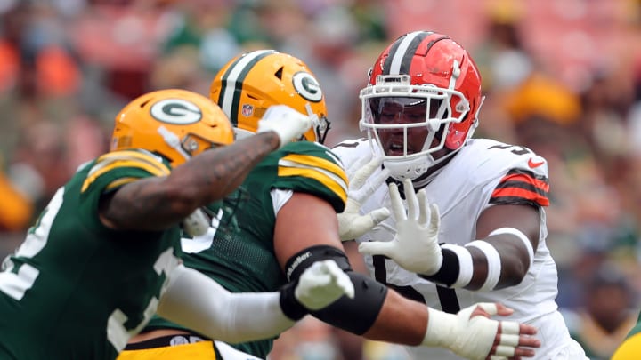 Cleveland Browns defensive tackle Mike Hall Jr. (51) works around a pair of Green Bay Packers defenders during the first half of an NFL preseason football game at Cleveland Browns Stadium, Saturday, Aug. 10, 2024, in Cleveland, Ohio.