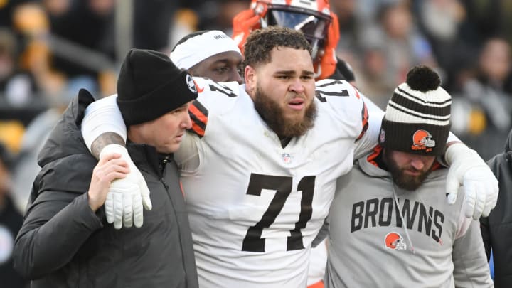 Jan 8, 2023; Pittsburgh, Pennsylvania, USA;  Injured Cleveland Browns tackle Jedrick Wills Jr. (71) is helped off the field in a game against the Pittsburgh Steelers during the fourth quarter at Acrisure Stadium. Mandatory Credit: Philip G. Pavely-USA TODAY Sports