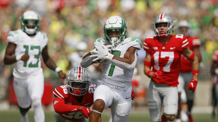 Sept. 11, 2021: Oregon running back CJ Verdell runs past Ohio State safety Bryson Shaw (17) and cornerback Cameron Brown (26) for a 77-yard touchdown on Sept. 11, 2021. Verdell scored two touchdowns.