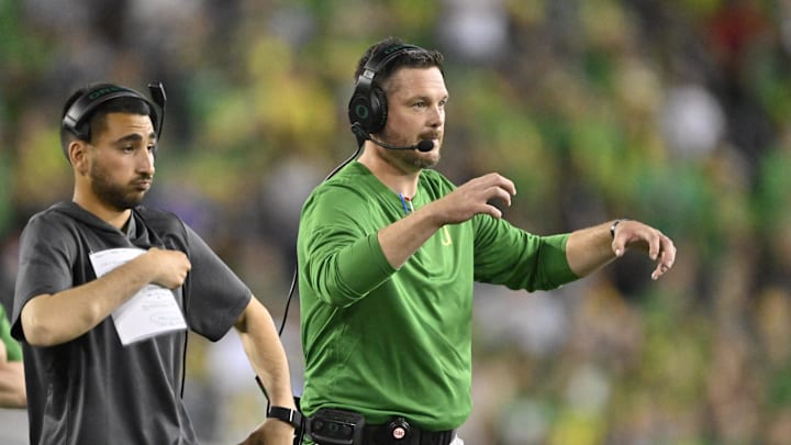 Sep 7, 2024; Eugene, Oregon, USA; Oregon Ducks head coach Dan Lanning signals his defense during the first half against the Boise State Broncos at Autzen Stadium. Mandatory Credit: Troy Wayrynen-Imagn Images