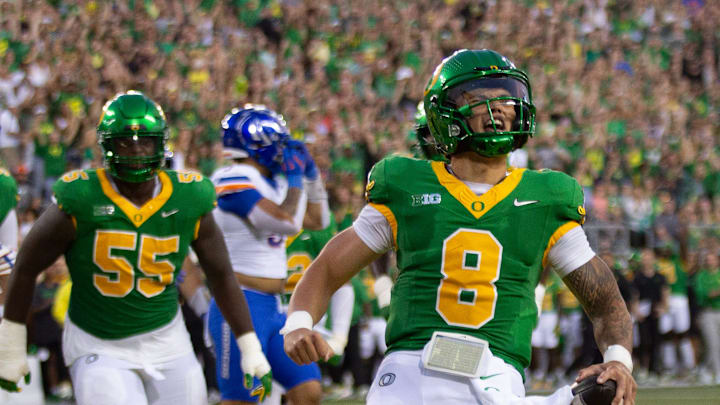 Oregon quarterback Dillon Gabriel, right, celebrates a first quarter touchdown against Boise State at Autzen Stadium in Eugene Sept. 7, 2024.