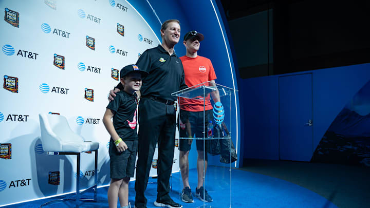 Beckett Bingham, 9, and father Clark Bingham take a photo with Oregon Ducks coach Dana Altman at the NCAA Men’s Final Four Fan Fest at the Phoenix Convention Center on April 7, 2024, in Phoenix.