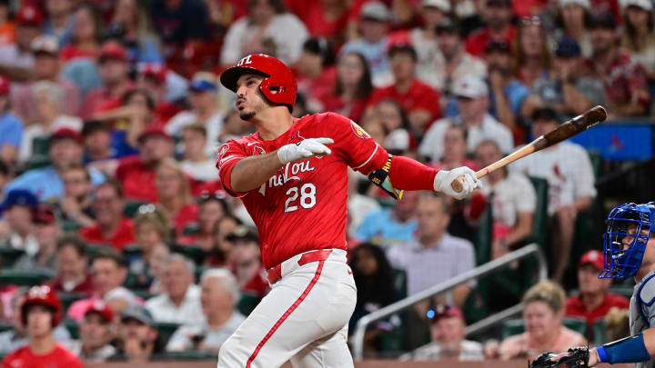 St. Louis Cardinals third base Nolan Arenado (28) hits a solo home run against the Los Angeles Dodgers in the eighth inning at Busch Stadium.  At right is Los Angeles Dodgers catcher Will Smith on Aug 17.