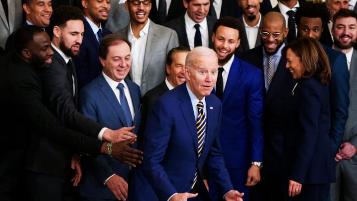 Jan 17, 2023; Washington, DC, USA; President Joe Biden fakes out members of the Golden State Warriors as he stands up after kneeling for a photograph during a ceremony in the East Room of the White House to celebrate their 2022 NBA championship. Mandatory Credit: Josh Morgan-USA TODAY