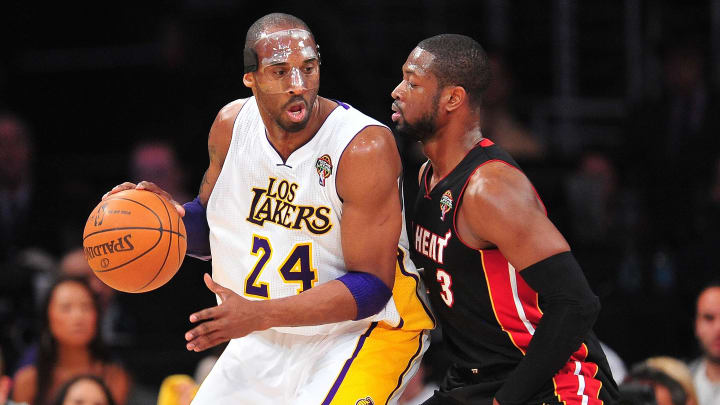 March 4, 2012; Los Angeles, CA, USA; Los Angeles Lakers shooting guard Kobe Bryant (24) controls the ball against the defense of Miami Heat shooting guard Dwyane Wade (3) during the first half at Staples Center. Mandatory Credit: Gary A. Vasquez-USA TODAY Sports