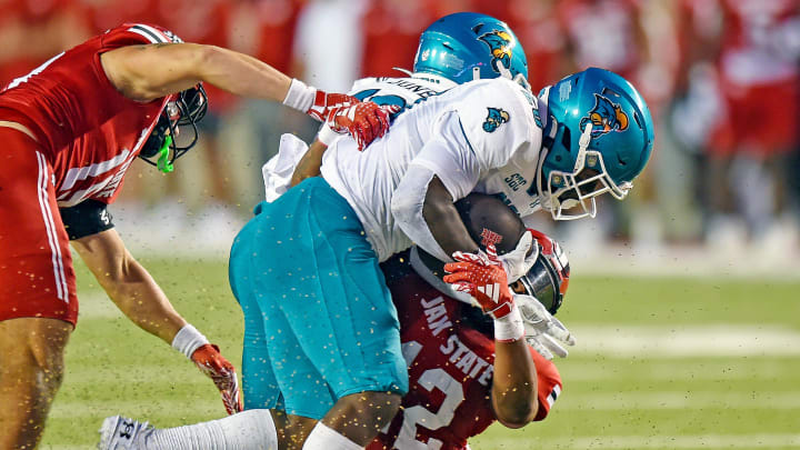 Coastal Carolina's Christian Washington tries to evade the tackle of Jacksonville State's Malcolm Jones during college football action at Burgess-Snow Field AmFirst Stadium in Jacksonville, Alabama August 29, 2024. (Dave Hyatt / Special to the Gadsden Times)