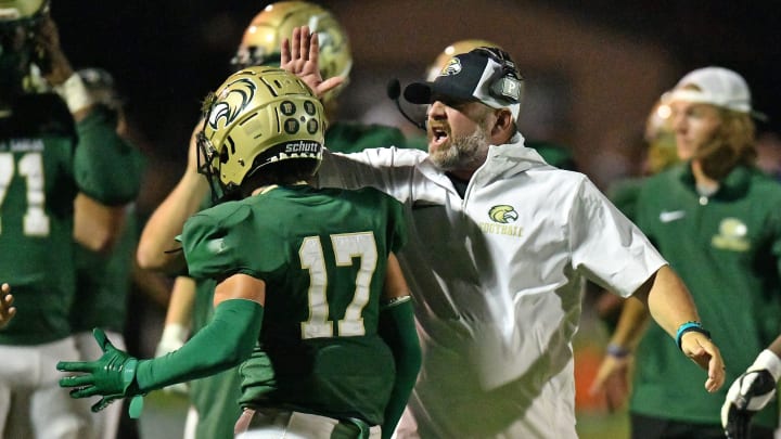 Fleming Island head coach Chad Parker celebrates with David Smith (17) after a goal line stand against the Bartram Trail Bears during a game last September. Parker will reportedly be released from his head coach duties on Wednesday according to sources with knowledge of the situation.