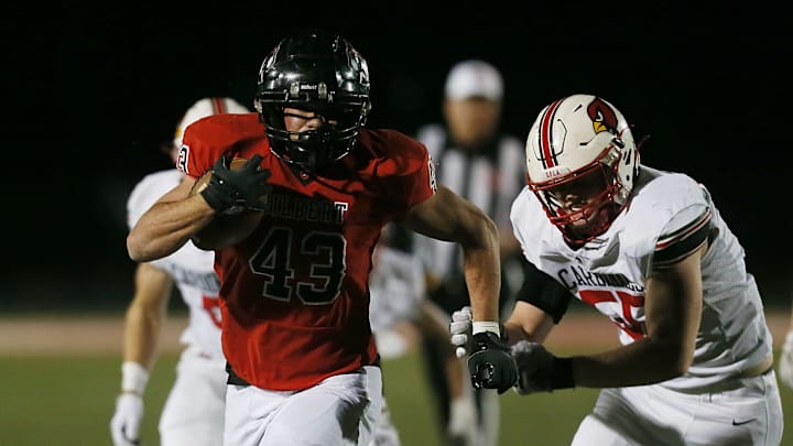 Gilbert's running back Will Hawthorne (43) runs for a touchdown as Newton's defender Nick Milburn (55) misses the tackle during first quarter at Tigers Stadium on Friday, Oct. 18, 2024, in Gilbert, Iowa Gilbert's running back Will Hawthorne (43) runs for a touchdown as Newton's defender Nick Milburn (55) misses the tackle during first quarter at Tigers Stadium on Friday, Oct. 18, 2024, in Gilbert, Iowa