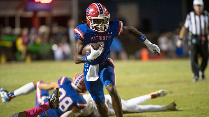 Pace High receiver Alijah Lavender (No. 3) evades the Aggie's defense to tack on extra yards after catching the ball during Friday night's home game against the Tate.