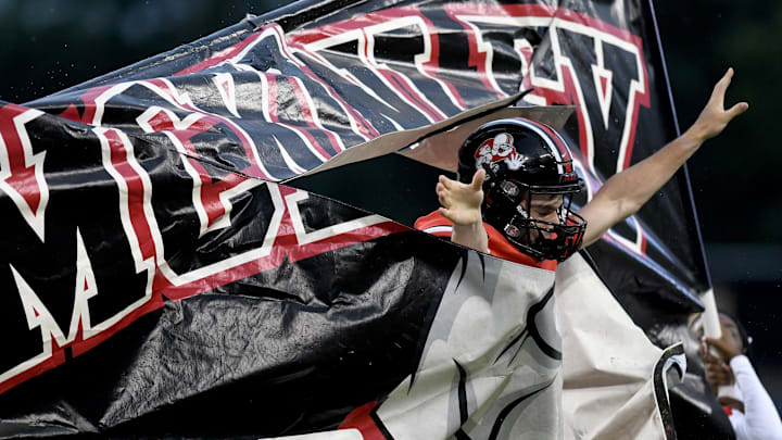 McKinley kicker Thomas Monkowski jumps through the banner before taking on Cass Tech at Canton McKinley football. Friday, September 6, 2024. McKinley kicker Thomas Monkowski jumps through the banner before taking on Cass Tech at Canton McKinley football. Friday, September 6, 2024.