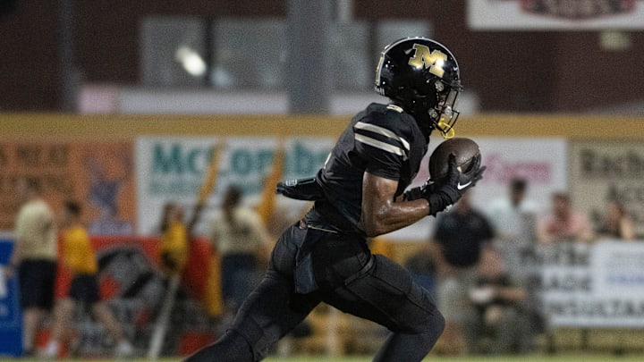 Milton's Kaiden Hall No. 3) pulls in the pass for a huge gain against the Gulf Breeze defense during Friday night's gridiron action. Milton's Kaiden Hall No. 3) pulls in the pass for a huge gain against the Gulf Breeze defense during Friday night's gridiron action.