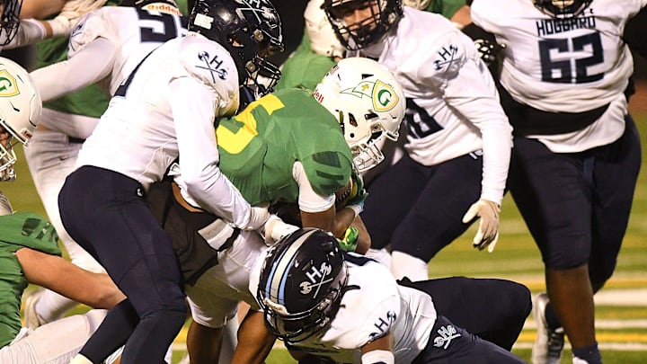 Hoggard's defense swarms the runner as Hoggard took on Gibbons Friday Dec. 6, 2024 in the Round 4 of 2024 NCHSAA playoff in Raleigh, N.C. KEN BLEVINS/STARNEWS