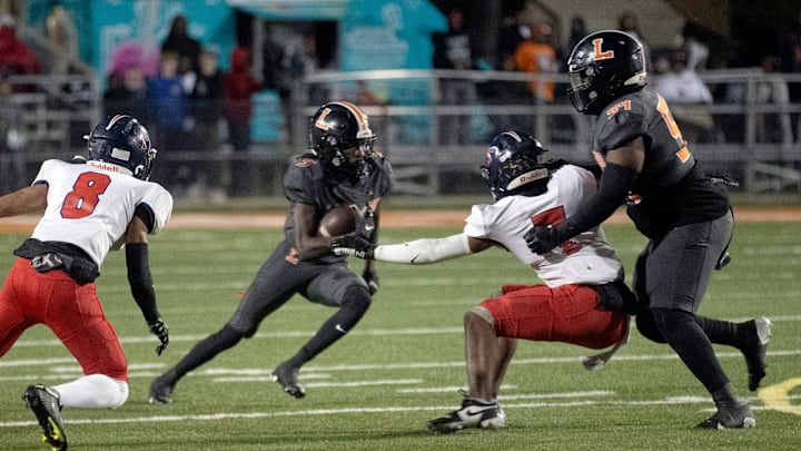 Lakeland's Shanard Clower looks for running room in the second quarter against Tampa Bay Tech on Friday night in the Class 5A, Region 2 final at Bryant Stadium /Roy Fuoco