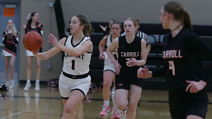 Gilbert guard Mia Kautman (1) passes the ball around Carroll's guard/forward Sophia Tidgren (20) and Carroll's guard Katelyn Aden (4) during the first quarter at Gilbert High School's gym on Monday, Feb. 5, 2024, in Gilbert, Iowa. Gilbert guard Mia Kautman (1) passes the ball around Carroll's guard/forward Sophia Tidgren (20) and Carroll's guard Katelyn Aden (4) during the first quarter at Gilbert High School's gym on Monday, Feb. 5, 2024, in Gilbert, Iowa.