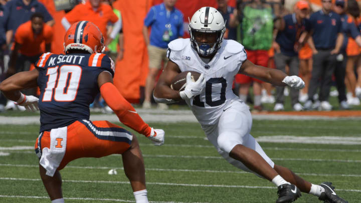 Sep 16, 2023; Champaign, Illinois, USA;  Penn State Nittany Lions running back Mehdi Flowers (right) runs the ball against Illinois Fighting Illini defensive back Miles Scott (10) during the first half at Memorial Stadium. Mandatory Credit: Ron Johnson-USA TODAY Sports