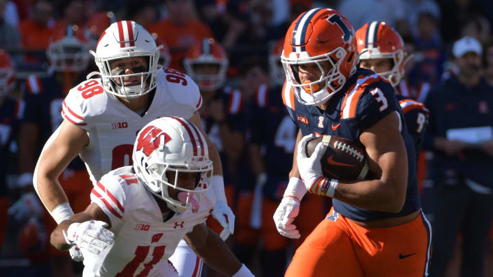 Oct 21, 2023; Champaign, Illinois, USA;  Illinois Fighting Illini running back Kaden Feagin (3) runs the ball against Wisconsin Badgers cornerback Alexander Smith (11) during the first half at Memorial Stadium. Mandatory Credit: Ron Johnson-USA TODAY Sports