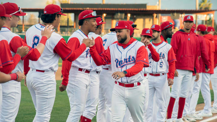 Stockton Ports' manager Javier Godard fist bumps his team at the start of the Ports' home opener against the Modesto Nuts at the Stockton Ballpark in downtown Stockton on Apr. 5, 2024.