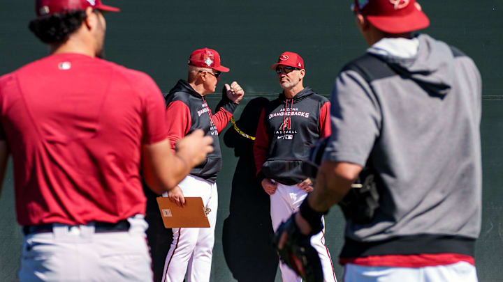 D-Backs manager, Torey Lovullo, right, talks with pitching coach, Brent Strom, while Humberto Castellanos, left, walks past at Salt River Fields at Talking Stick on March 11, 2022 in Scottsdale, Arizona.

Mlb Baseball Returns