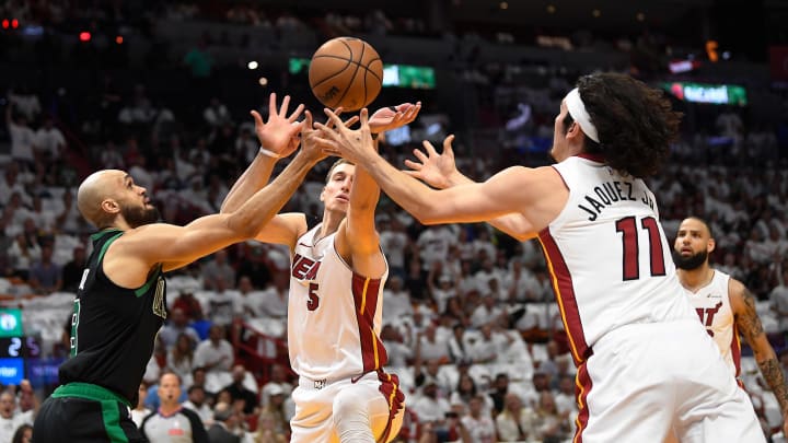 Apr 29, 2024; Miami, Florida, USA; Miami Heat forward Nikola Jovic (5), and Miami Heat guard Jaime Jaquez Jr. (11) reach for the ball against Boston Celtics guard Derrick White (9) during the first quarter of game four of the first round for the 2024 NBA playoffs at Kaseya Center. Mandatory Credit: Michael Laughlin-USA TODAY Sports