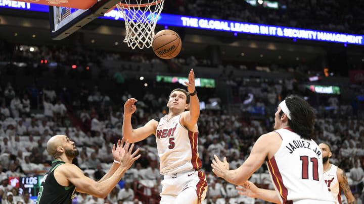 Apr 29, 2024; Miami, Florida, USA; Miami Heat forward Nikola Jovic (5) reaches for the ball in front of Boston Celtics guard Derrick White (9) during the first quarter of game four of the first round for the 2024 NBA playoffs at Kaseya Center. Mandatory Credit: Michael Laughlin-USA TODAY Sports