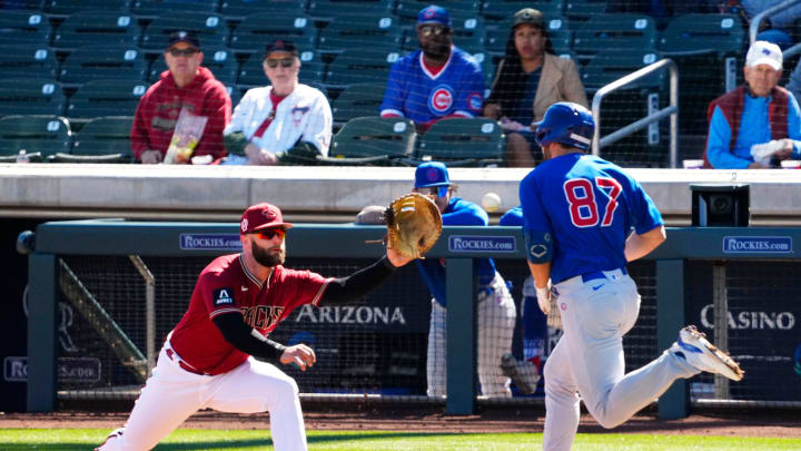 Arizona Diamondbacks first baseman Christian Walker (53) makes the out on Chicago Cubs Jake Slaughter (87) in the third inning during a spring training game at Salt River Fields on Feb. 27, 2023.