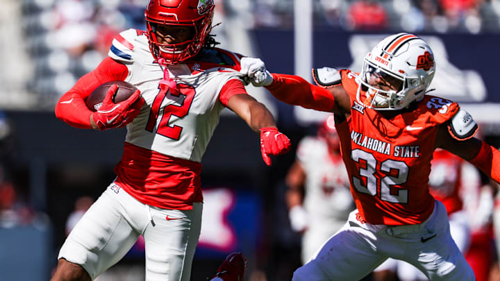 Oct 4, 2025; Tucson, Arizona, USA; Oklahoma State Cowboys safety Mordecai McDaniel (32) grabs Arizona Wildcats wide receiver Tre Spivey (12) during the third quarter of the game at Arizona Stadium. Mandatory Credit: Aryanna Frank-Imagn Images Oct 4, 2025; Tucson, Arizona, USA; Oklahoma State Cowboys safety Mordecai McDaniel (32) grabs Arizona Wildcats wide receiver Tre Spivey (12) during the third quarter of the game at Arizona Stadium. Mandatory Credit: Aryanna Frank-Imagn Images