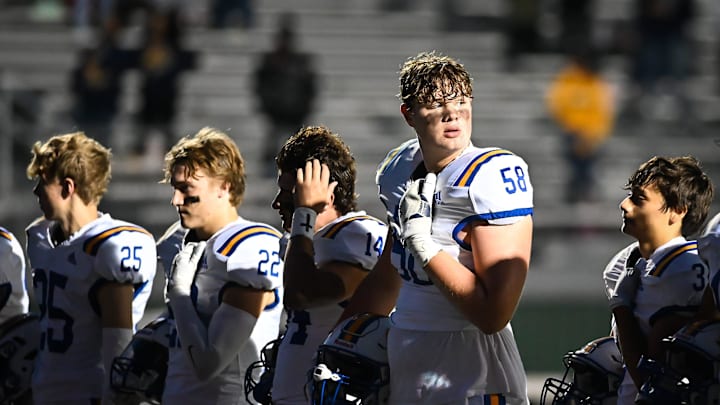 Catholic Memorial offensive tackle Owen Strebig (58) and teammates participate in pregame ceremonies before the game against Pius XI on Friday, September 29, 2023, at Raabe Stadium in Wauwatosa, Wisconsin.