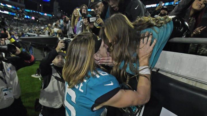 Jacksonville Jaguars quarterback Trevor Lawrence (16) gets a kiss from his wife Marissa from the stands after Saturday night's victory over the Tennessee Titans. The Jacksonville Jaguars hosted the Tennessee Titans to decide the AFC South championship at TIAA Bank Field in Jacksonville, FL, Saturday, January 7, 2023. The Jaguars went into the half trailing 7 to 13 but came back to win with a final score of 20 to 16. [Bob Self/Florida Times-Union]